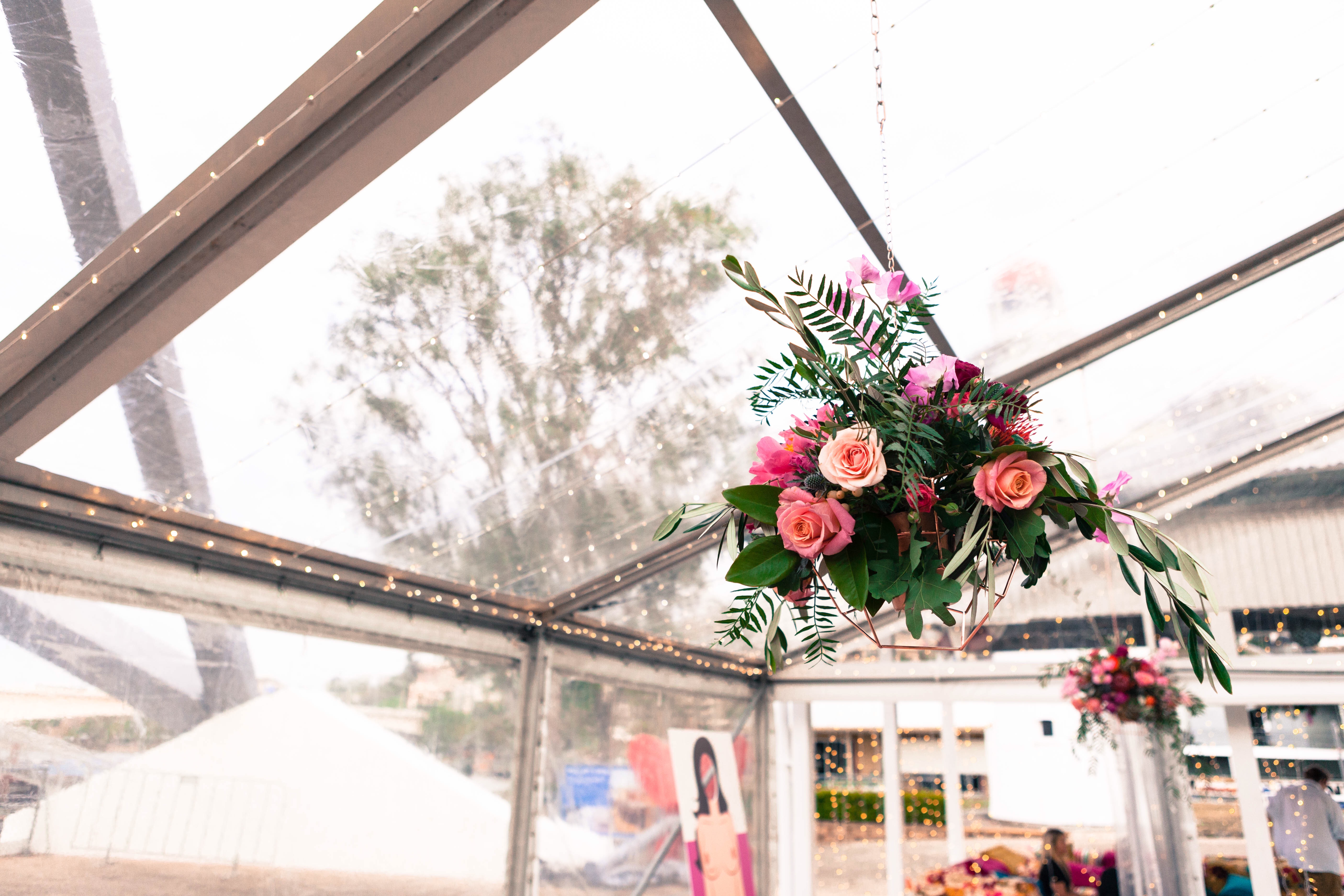 The floral arrangement hanging in the marquee