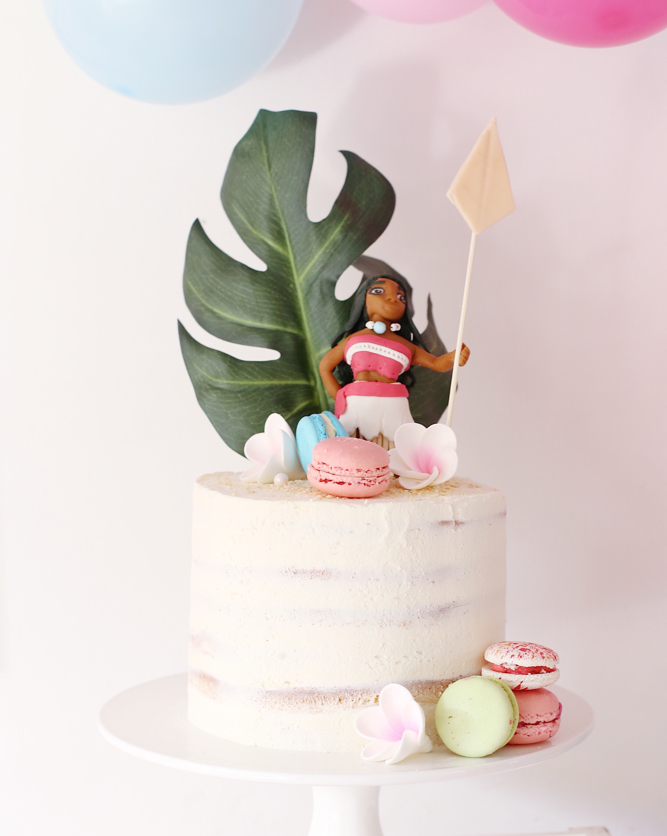 Moana party cake with macarons and Moana topper