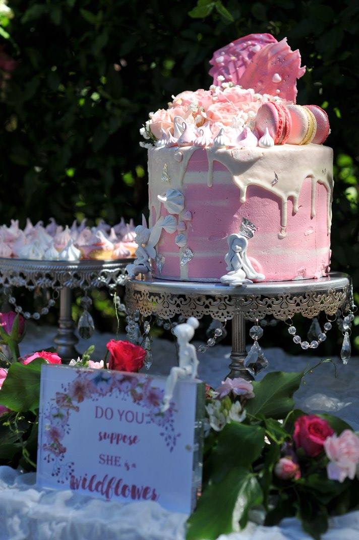 The cake was embellished with macarons and meringues