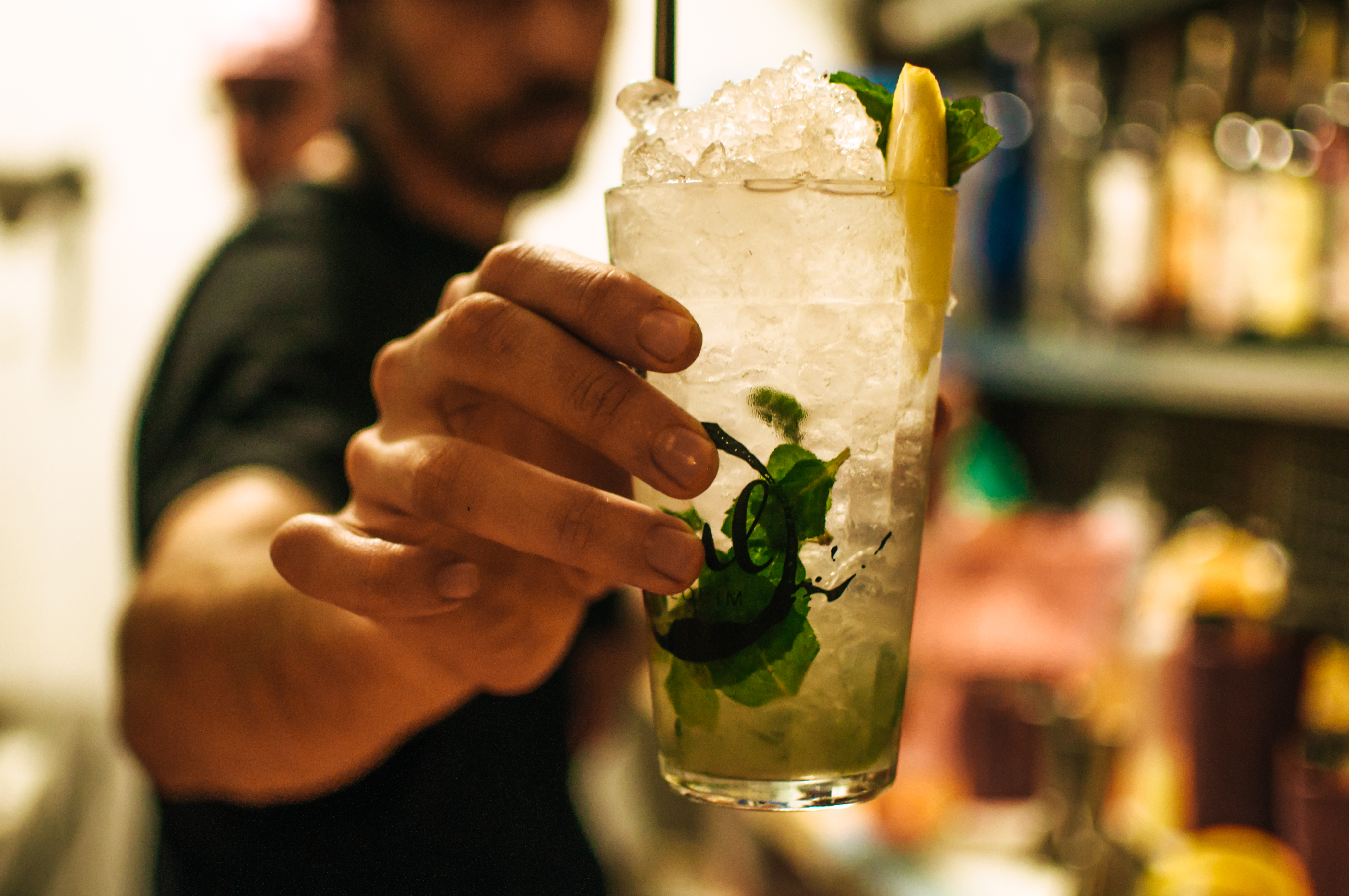 Barman holding a mohito.