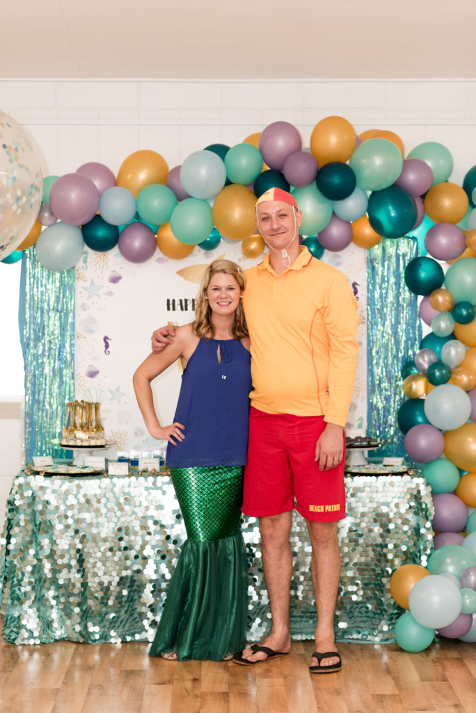 Mum and dad dressed as a mermaid and life guard. 