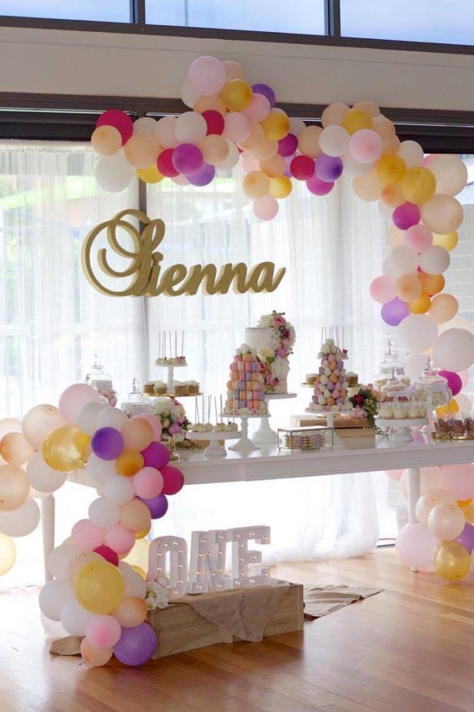 Balloon garland at a pink, white and gold first birthday