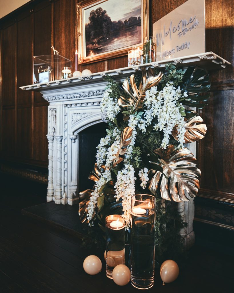Gold and green luxe floral fireplace arrangement