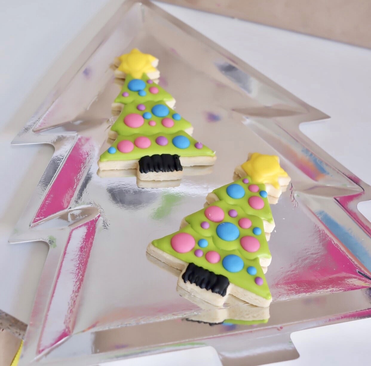 Neon Christmas tree cookies on sliver Christmas tree plate