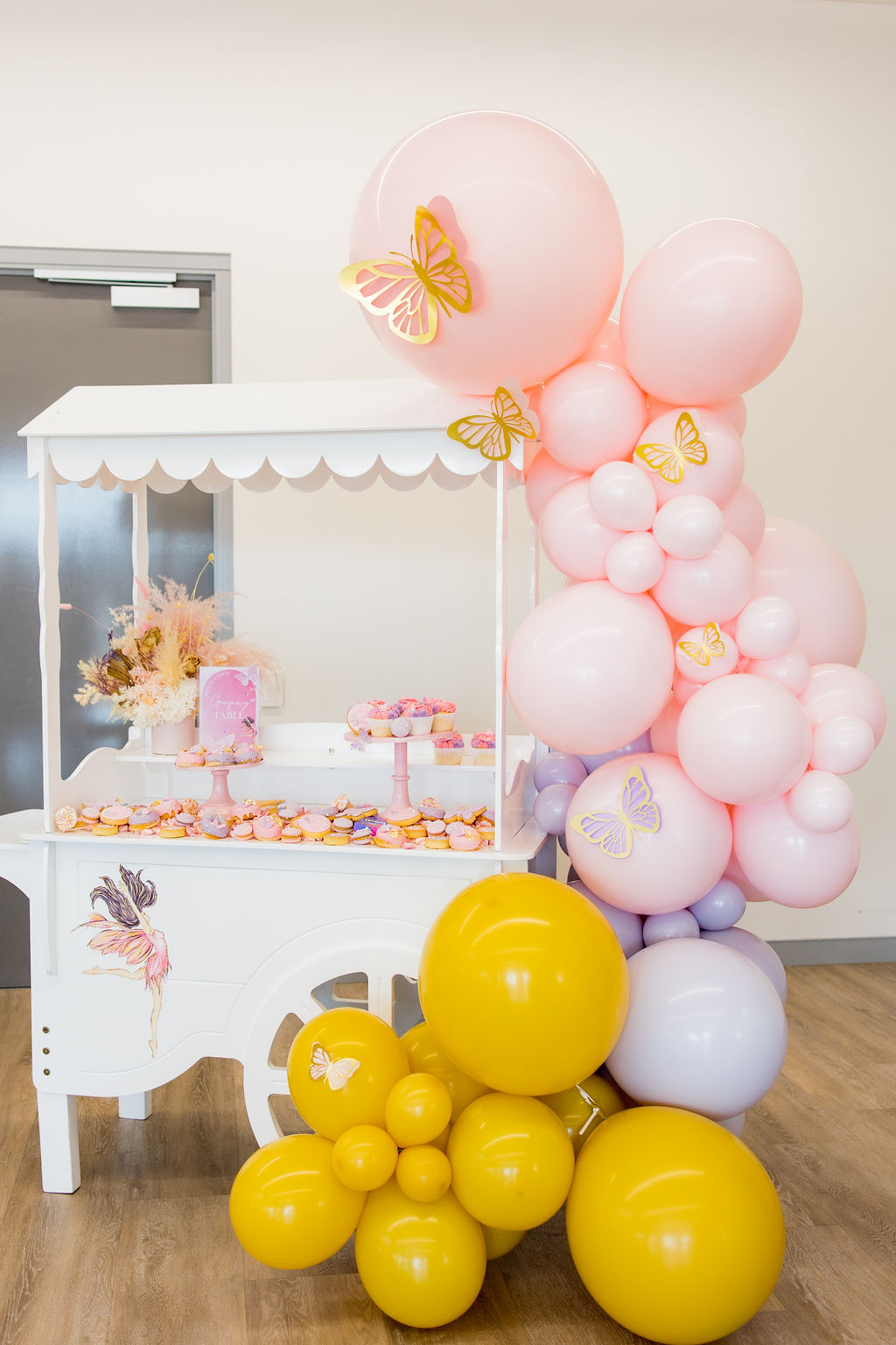 A mustard, purple and pastel pink butterfly first birthday party