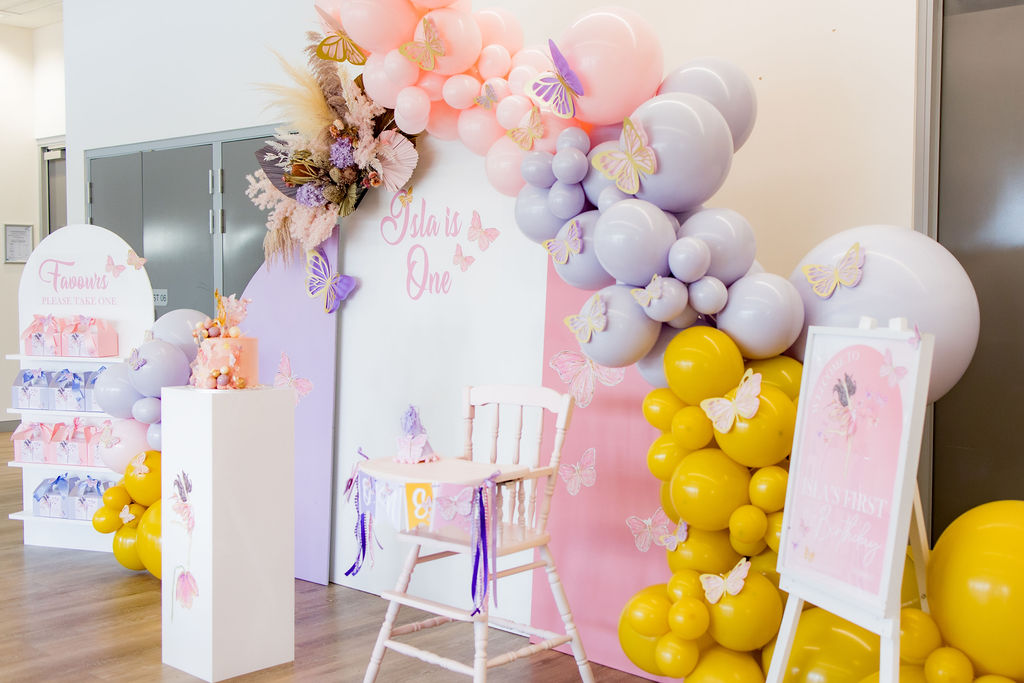 A mustard, purple and pastel pink butterfly first birthday party