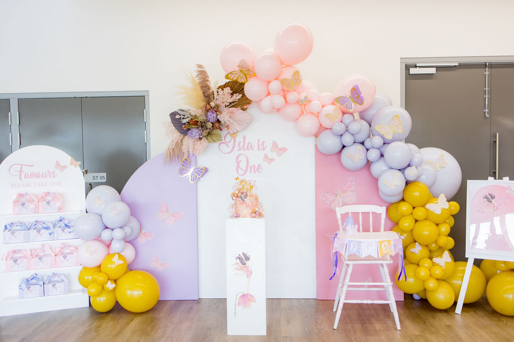 A mustard, purple and pastel pink butterfly first birthday party