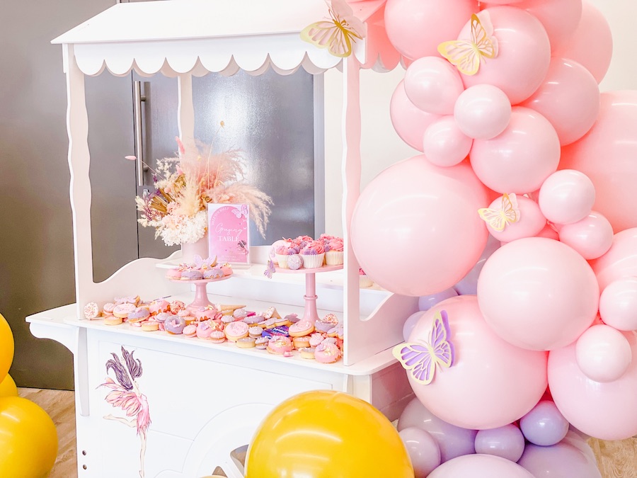 A mustard, purple and pastel pink butterfly first birthday party
